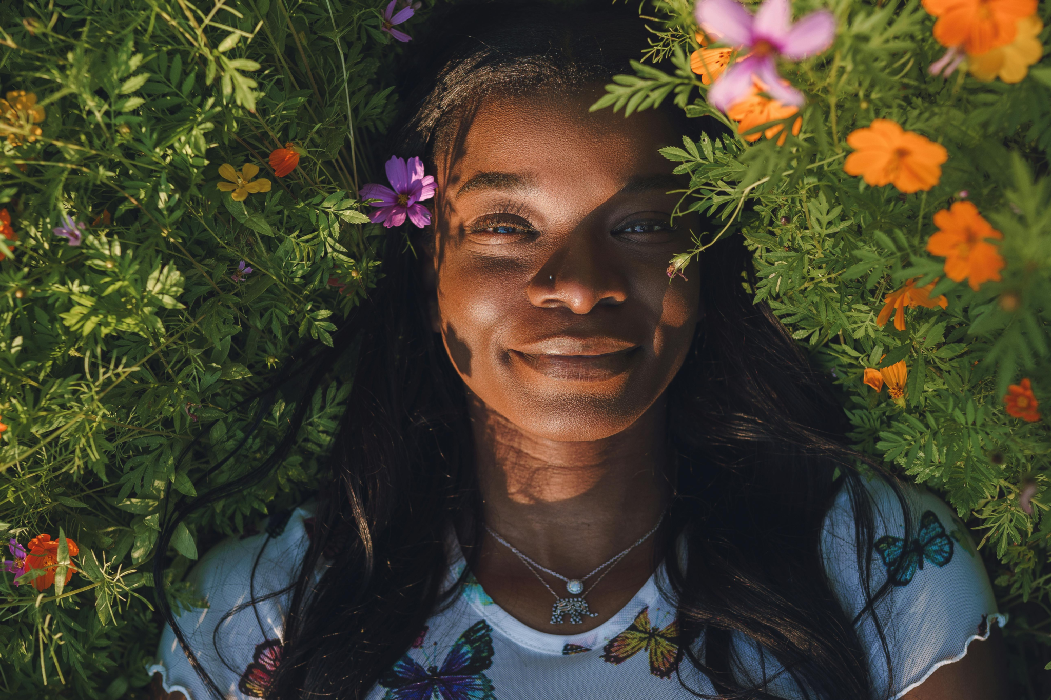 Woman lying in a field of flowers